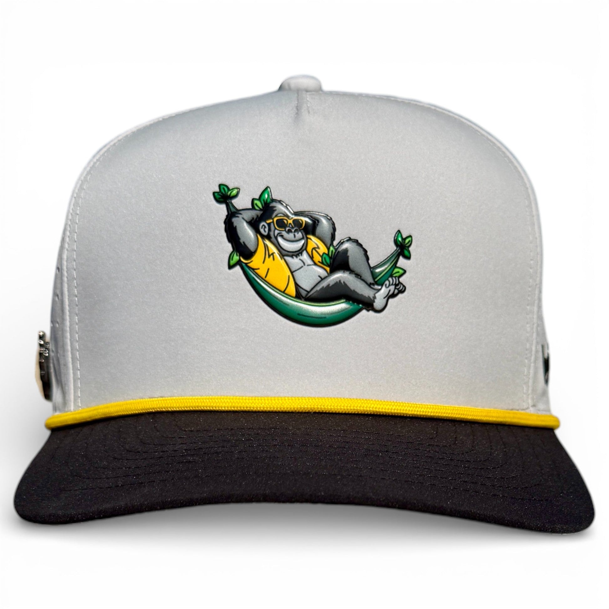 Logie Joe’s Golf Banana Hammock Snapback Cap features a relaxed gorilla in sunglasses on a gray and black hat with yellow trim, plus a built-in magnetic ball marker. Adjustable, one size—a playful vibe for the course.