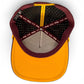 A top-down view of Logie Joe's Golf Cold One Snapback Cap shows patterned lining, branded taping, a MAKE YOUR MARK label, and an adjustable fit. The yellow brim contrasts with the maroon crown. Includes built-in magnetic ball marker holder plus marker.