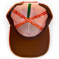 The Just Peachy Golf Hat by Logie Joe's Golf is a peach snapback cap with a perforated lining, colorful bands, and a green MAKE YOUR MARK band. It features an adjustable fit plus a built-in magnetic ball marker holder and included marker.