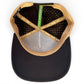 Top-down view of Logie Joe’s Golf Hunting Birdies Snapback Hat in tan and black, featuring a built-in magnetic ball marker holder with marker, adjustable fit, ventilation perforations, and interior taping reading “MAKE YOUR MARK” and “Legacy 100.”.