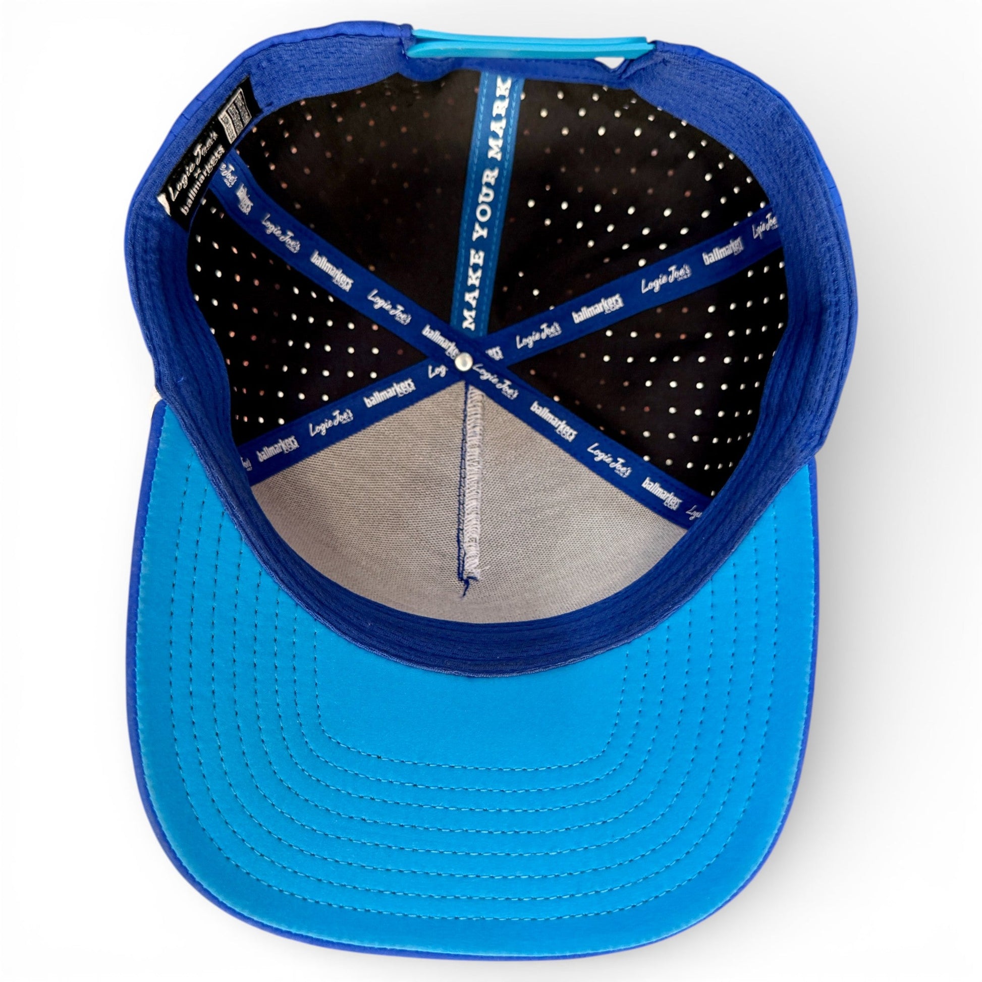 Top view of the Logie Joe's Golf Water Ball Golf Hat in blue, featuring brim, inner stitching, perforated sweatband, and blue tape with "MAKE YOUR MARK" and "Lego Kids." Snapback cap comes with built-in magnetic ball marker holder and marker.