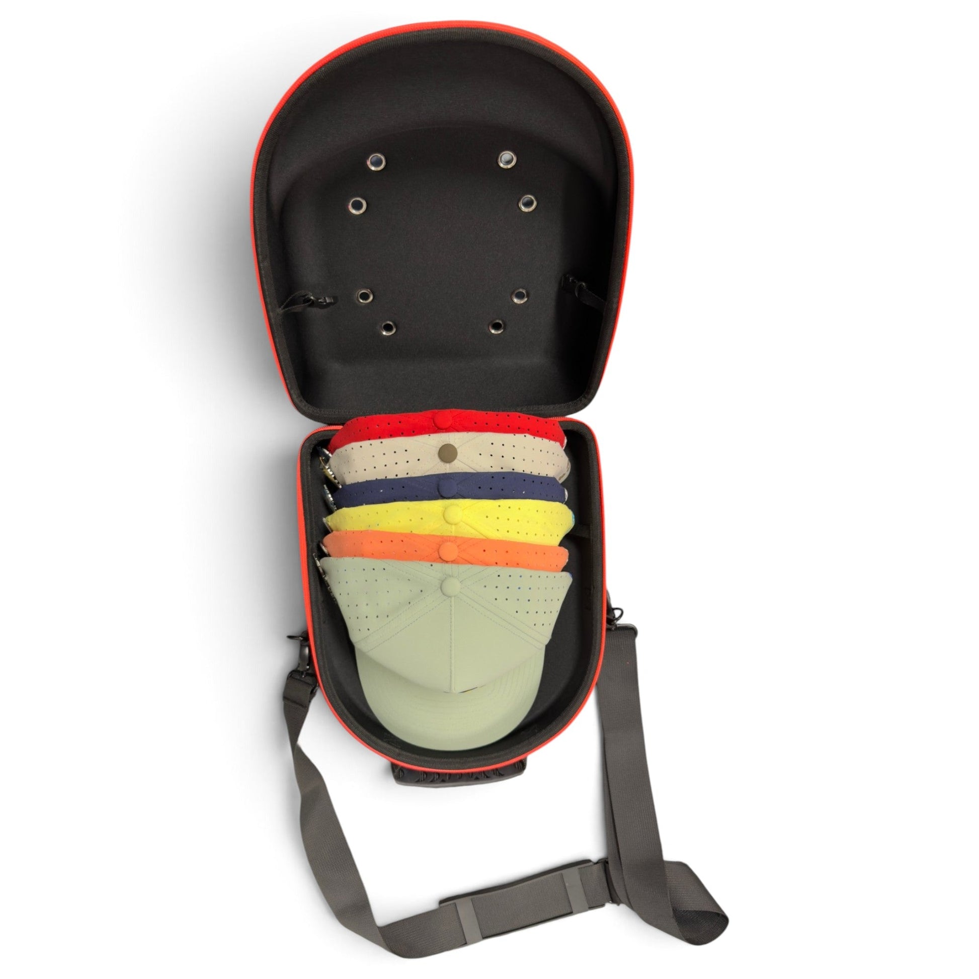 The Logie Joe’s Golf Hat Caddy Travel Case—a hard shell hat carrier with an adjustable shoulder strap—is open, displaying five colorful baseball caps stacked neatly inside.