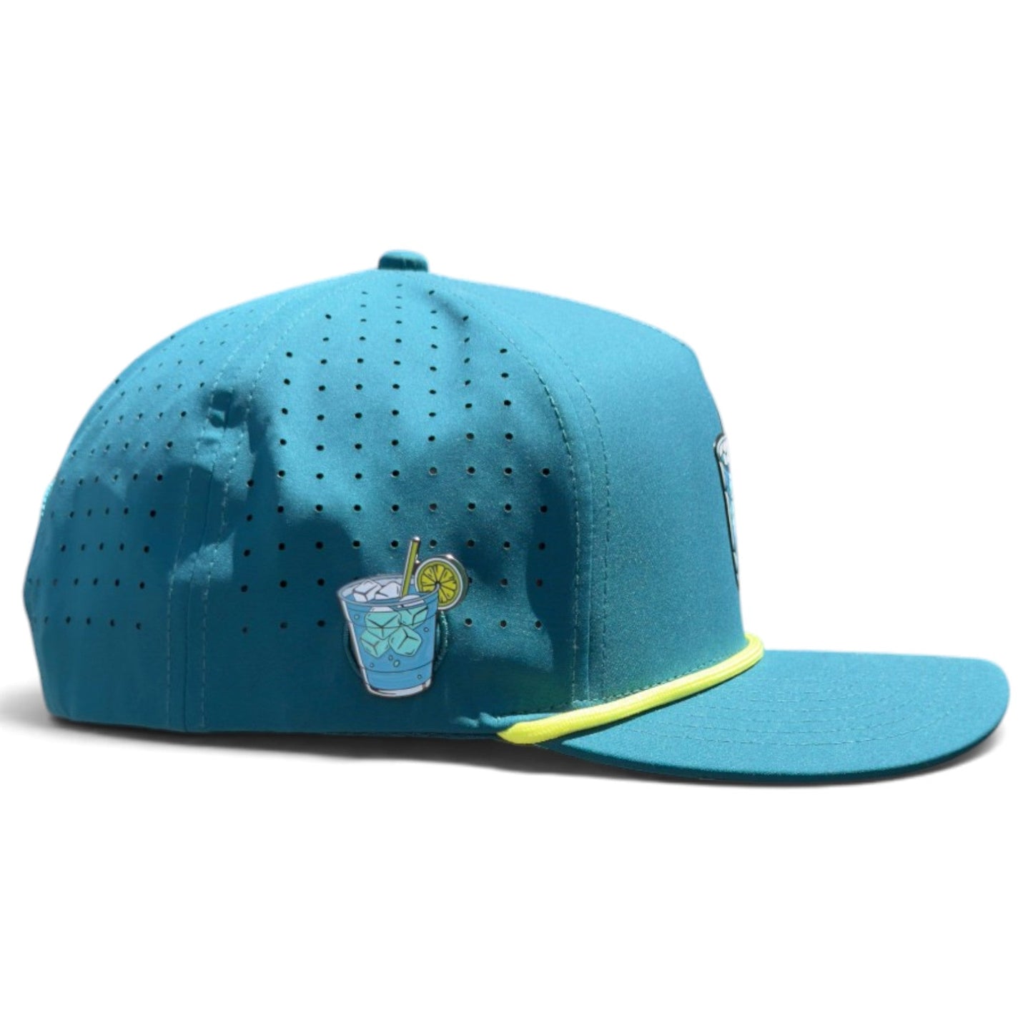 Introducing the Water Hazard Golf Hat from Logie Joe’s Golf—a blue snapback cap with a yellow trim, featuring a small embroidered patch of a refreshing drink with ice, straw, and lemon slice on the side. This stylish golf hat offers breathable perforations for comfort, an adjustable fit, and comes equipped with a built-in magnetic ball marker holder (plus marker included) to enhance your game.