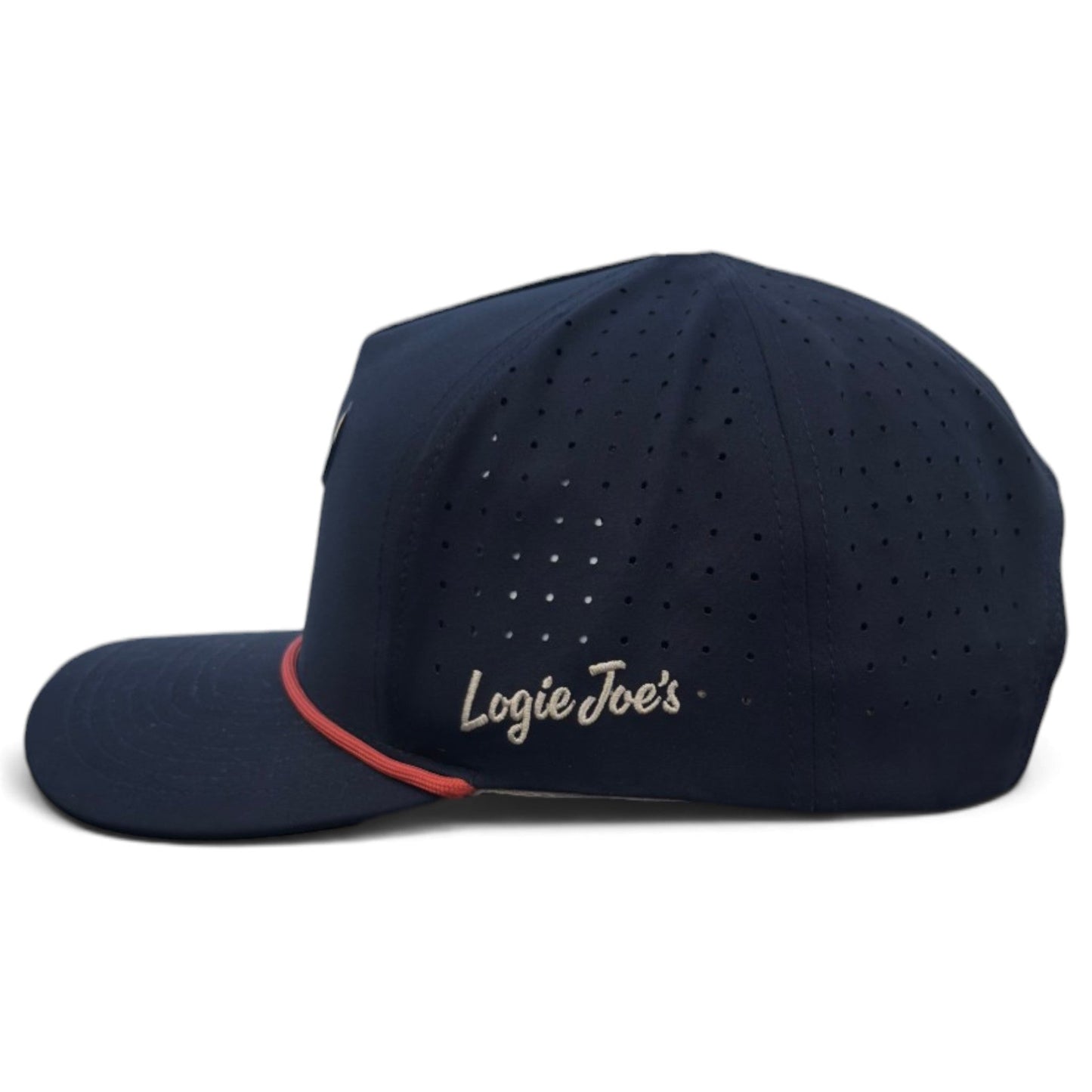Outlaw Golf Hat by Logie Joe’s Golf in navy blue, featuring a curved visor and small ventilation holes. The side displays the Logie Joe’s Golf logo embroidered in white. A thin red trim accents the base of the front panel above the visor, and an integrated magnetic ball marker holder with included marker adds functionality. Adjustable snapback fit; Bull Skull design.
