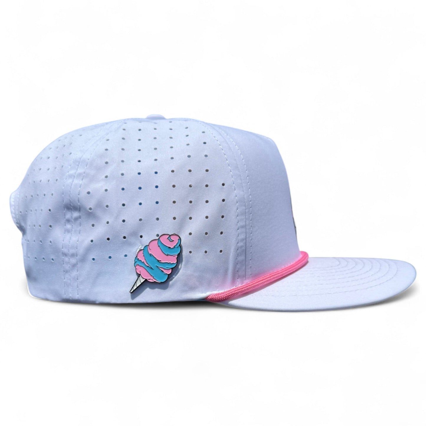 The Sugar Rush Golf Hat by Logie Joe's Golf is a light blue snapback cap with silver dots, pink trim, and a cotton candy pin. It features an adjustable fit plus a magnetic ball marker holder and is shown on a white background.