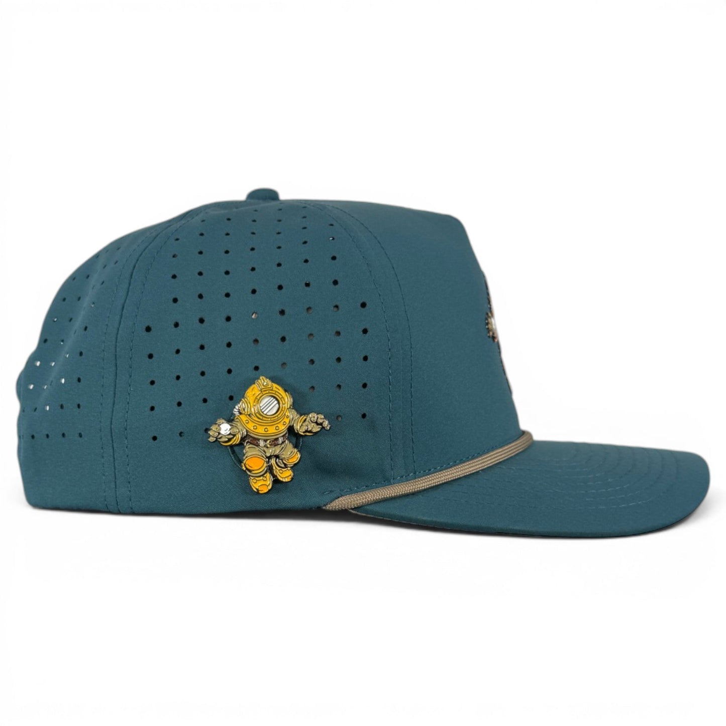 Experience standout style on the course with Logie Joe’s Golf Deep Dive Golf Hat—a teal adjustable snapback cap featuring perforated holes, a built-in magnetic ball marker holder (with marker included), and a small yellow and orange deep-sea diver pin on the side. The perfect way to add personality to your favorite golf hat!.