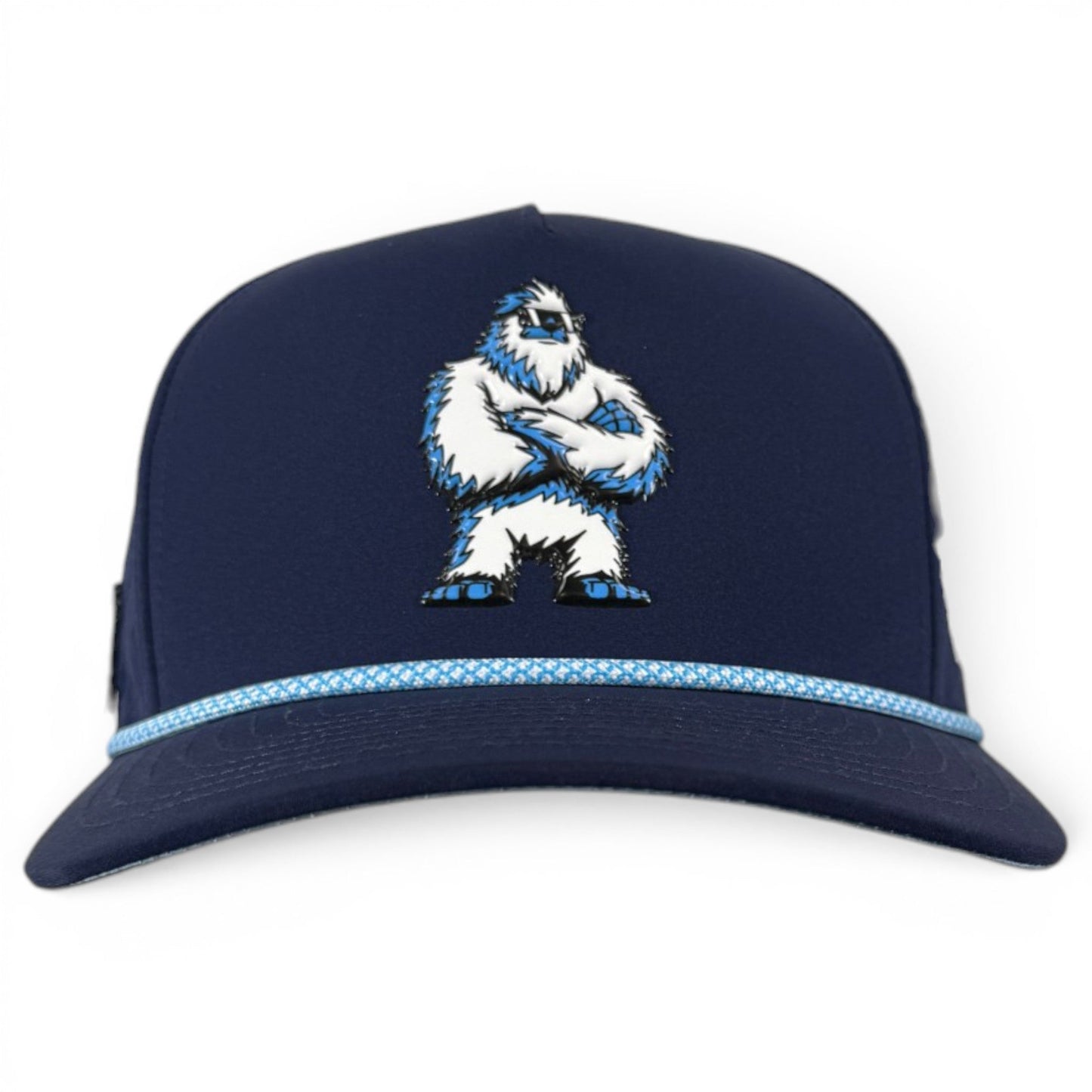 Introducing the Zero Chill Yeti Golf Hat from Logie Joe’s Golf—a navy adjustable snapback cap featuring a white and blue abominable snowman with crossed arms on the front, and a light blue patterned band above the brim. This breathable golf hat keeps you cool on the course and comes equipped with a built-in magnetic ball marker holder plus marker, blending standout style with practical features for every round.