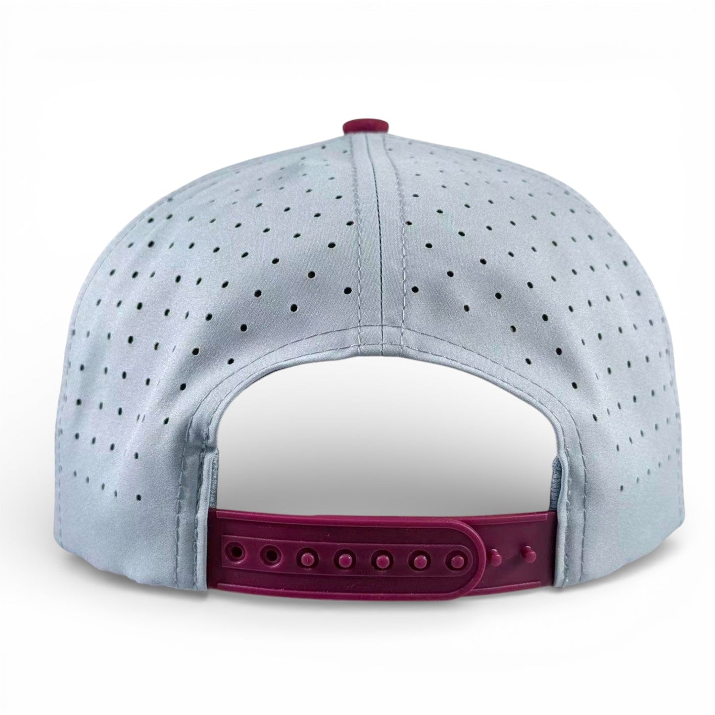 The Logie Joe's Golf Transfusion Golf Hat is a light gray snapback cap shown from the back, featuring a maroon adjustable closure, ventilation holes, and a built-in magnetic ball marker holder with marker included.