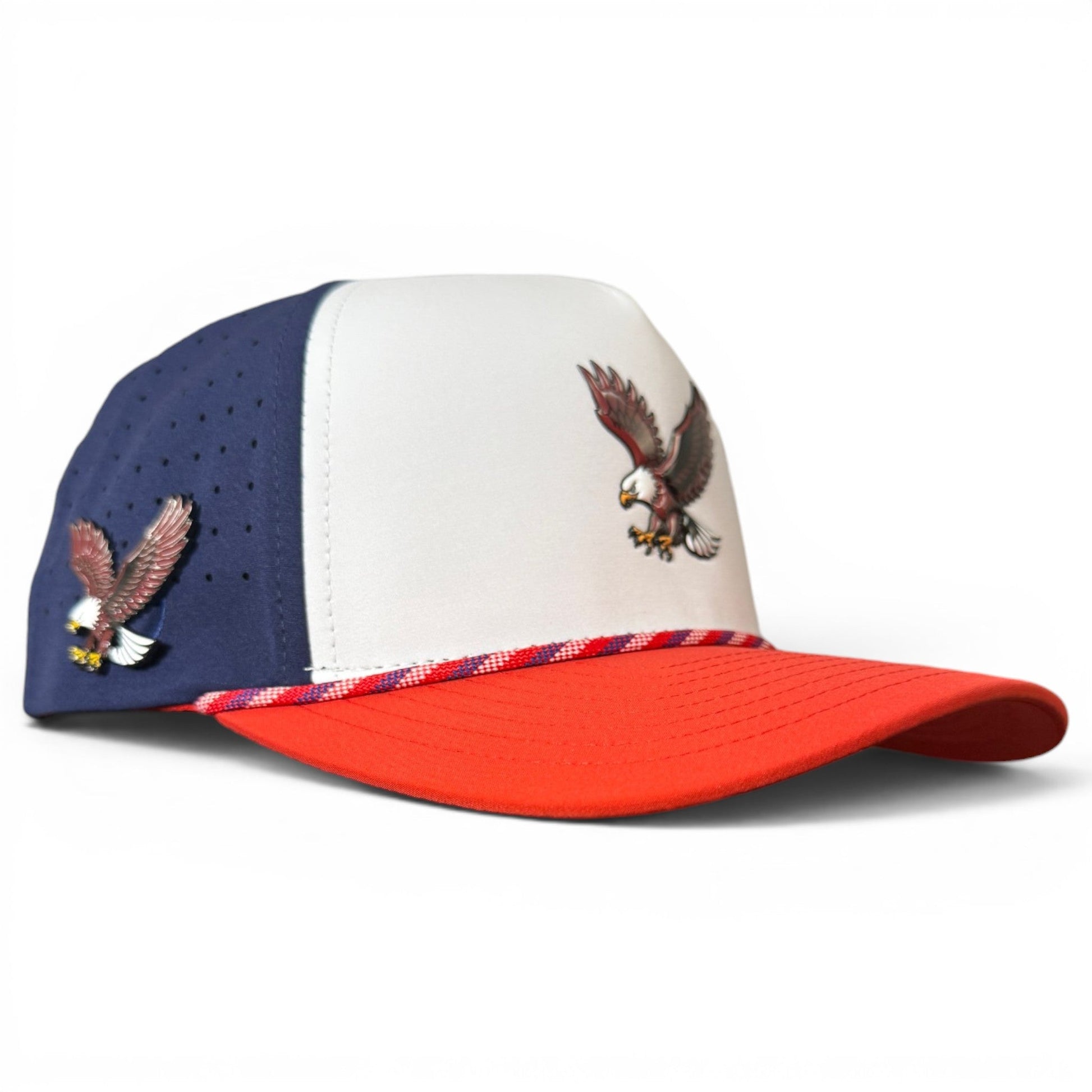 Introducing the Freedom Flight Golf Hat by Logie Joe’s Golf—a red, white, and blue snapback cap featuring an eagle patch on the front panel and a smaller eagle detail on the blue side panel. The adjustable hat boasts a red brim with a patriotic braided accent above it, plus a built-in magnetic ball marker holder and included marker—an iconic accessory celebrating classic American style.