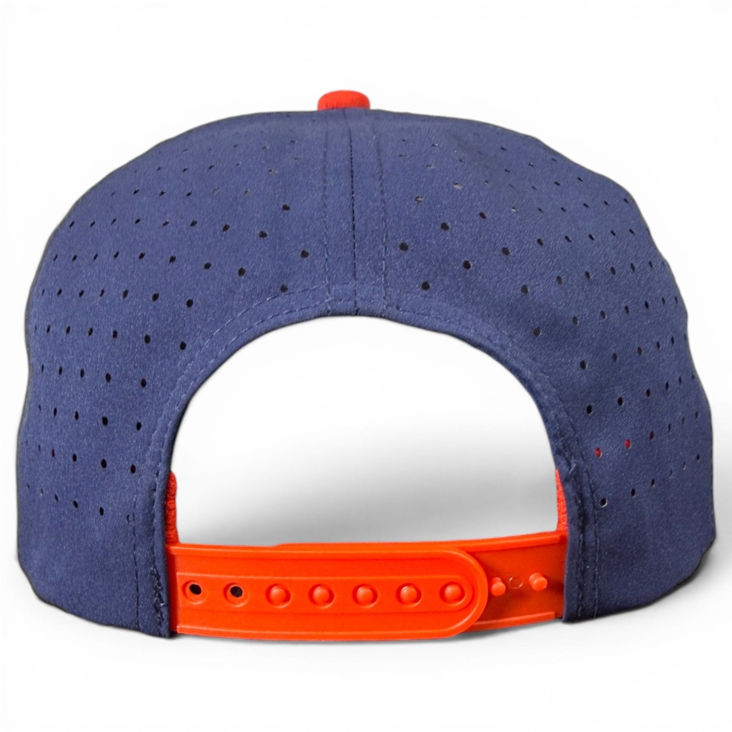 A rear view of the Logie Joe’s Golf Freedom Flight Golf Hat showcases its classic American style, featuring a navy blue design with a red adjustable snapback closure, small ventilation holes throughout the fabric, and a built-in magnetic ball marker holder with marker included—perfectly combining timeless golf hat appeal with practical innovation.