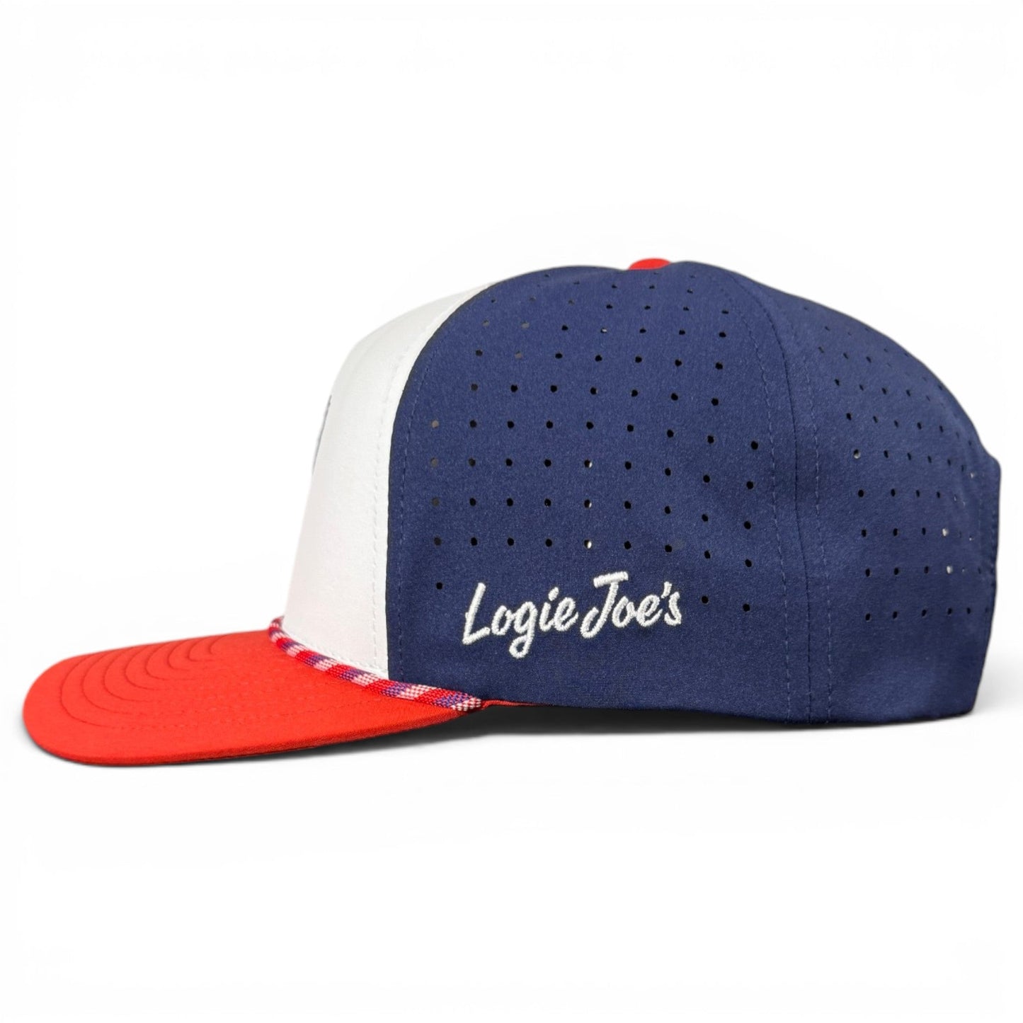 Sure! Here’s a rewritten sentence using the provided product data: The Freedom Flight Golf Hat by Logie Joe’s Golf is an American-style adjustable snapback cap in red, white, and blue, featuring an embroidered side logo, perforated blue panels, a red brim with braided trim, and a built-in magnetic ball marker holder with marker included.
