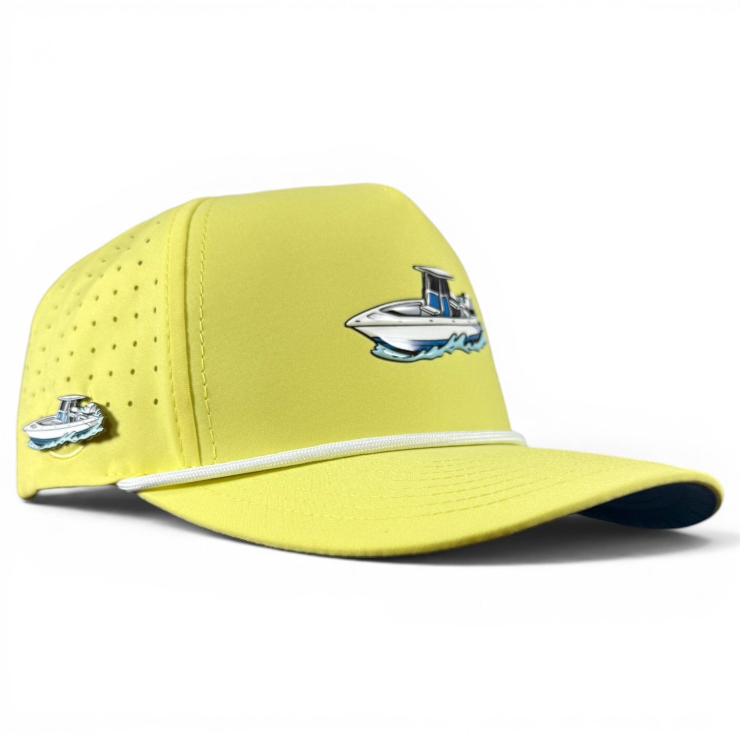 Introducing the Motor Boatin’ Golf Hat by Logie Joe’s Golf—a vibrant yellow snapback cap featuring a small boat illustration on the front and side. This versatile golf hat is designed with a white cord above the brim, side ventilation holes, and an adjustable snapback closure for a comfortable, perfect fit. Plus, it includes a built-in magnetic ball marker holder and marker!.