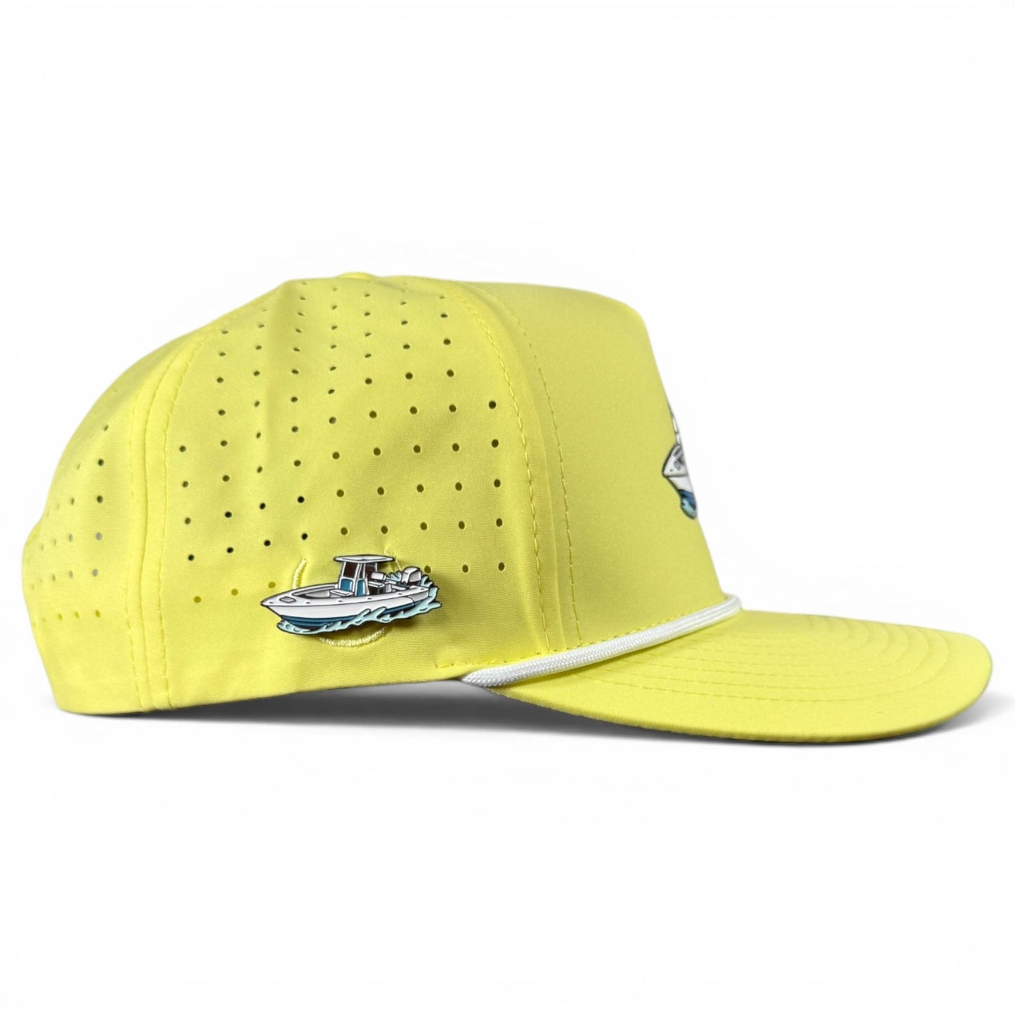 Logie Joe’s Golf Motor Boatin’ Golf Hat is a yellow perforated snapback cap featuring a white rope detail above the brim, an adjustable fit, and includes a built-in magnetic ball marker holder with marker; it also sports a small blue and white boat pin on the side.