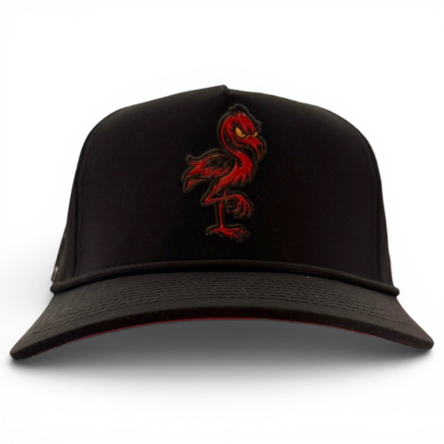 Introducing the Jogie Loe’s Flamingo Golf Hat by Logie Joe’s Golf—a black adjustable snapback cap showcasing an embroidered red flamingo logo on the front. Displayed against a white background, this stylish golf hat features a built-in magnetic ball marker holder with marker included for added convenience on the course.