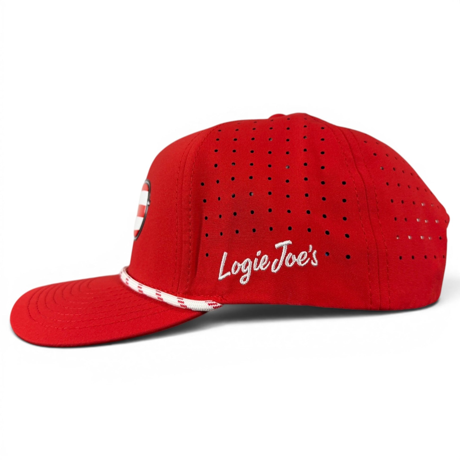 Here’s a revised version of your sentence using the provided product data: The Red, White & View Golf Hat by Logie Joe’s Golf features a bold red snapback design with ventilation holes, white “Logie Joe’s” branding on the side, and a stylish white-and-red striped band above the brim. With its built-in magnetic ball marker holder (marker included) and adjustable fit, this patriotic cap is ideal for displaying your USA spirit at any event. Pair it with American flag sunglasses for an extra festive touch!.