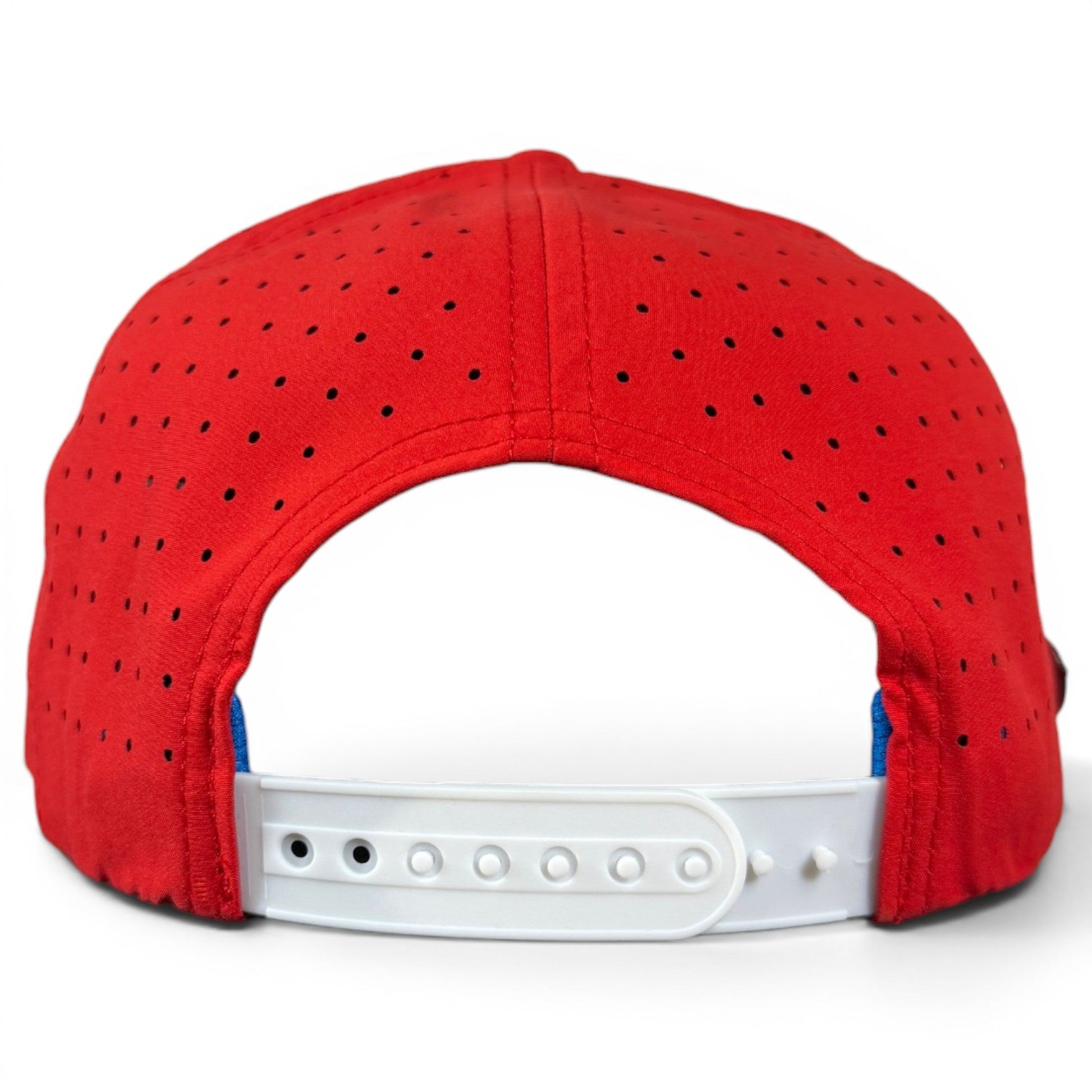Back view of the Red, White & View Golf Hat by Logie Joe’s Golf—a red perforated snapback cap featuring a white adjustable closure and built-in magnetic ball marker holder (marker included), displayed on a plain white background—an ideal patriotic accessory for any occasion.