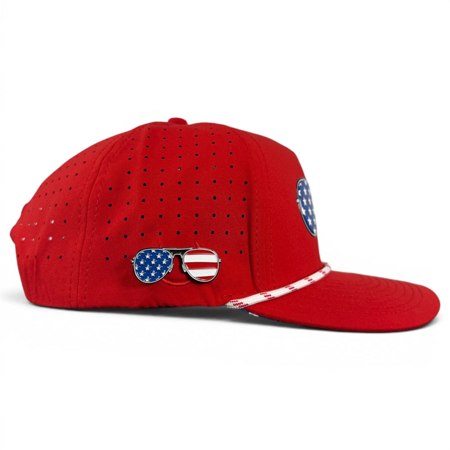 Introducing the Logie Joe’s Golf Red, White & View Snapback Cap: this patriotic adjustable hat features ventilation holes and a magnetic ball marker holder with a USA shades-shaped marker attached to the side.