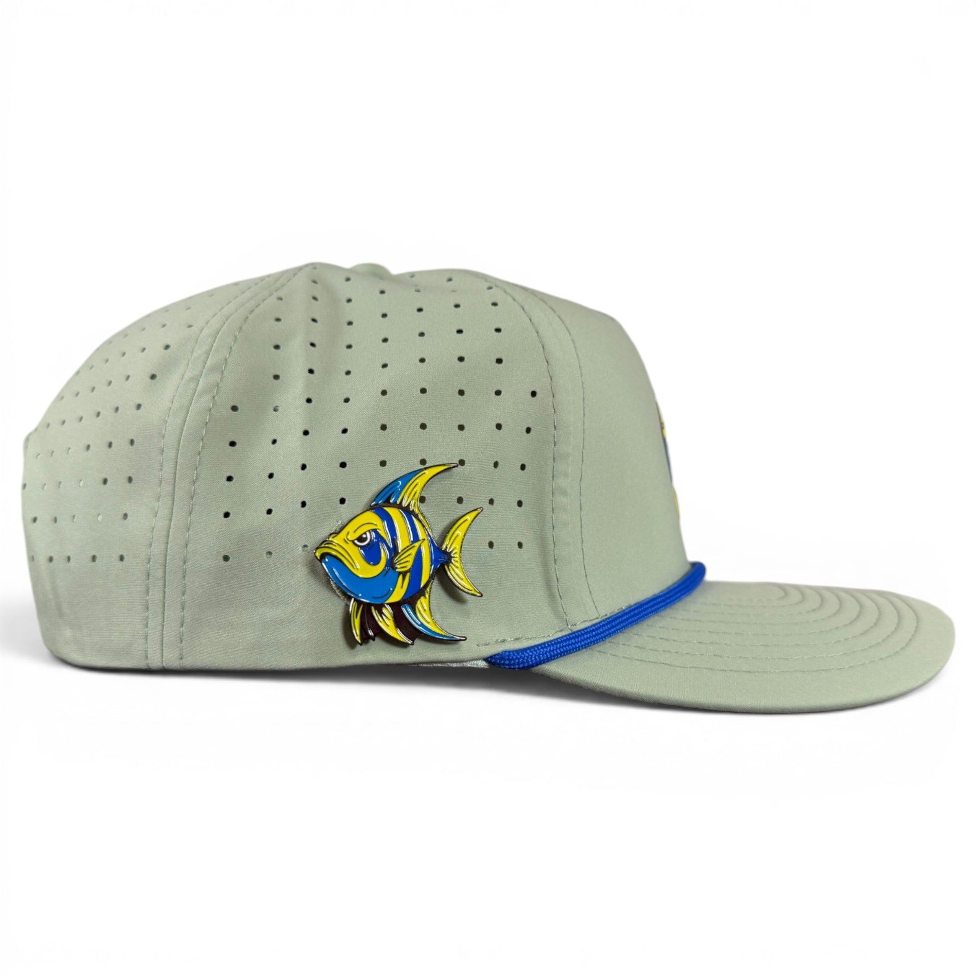 A light gray Logie Joe’s Golf Angelfish Golf Hat featuring small ventilation holes, a colorful fish design on the side, and a blue trim above the brim. This adjustable snapback cap includes a built-in magnetic ball marker holder with marker for all-day comfort on the course.