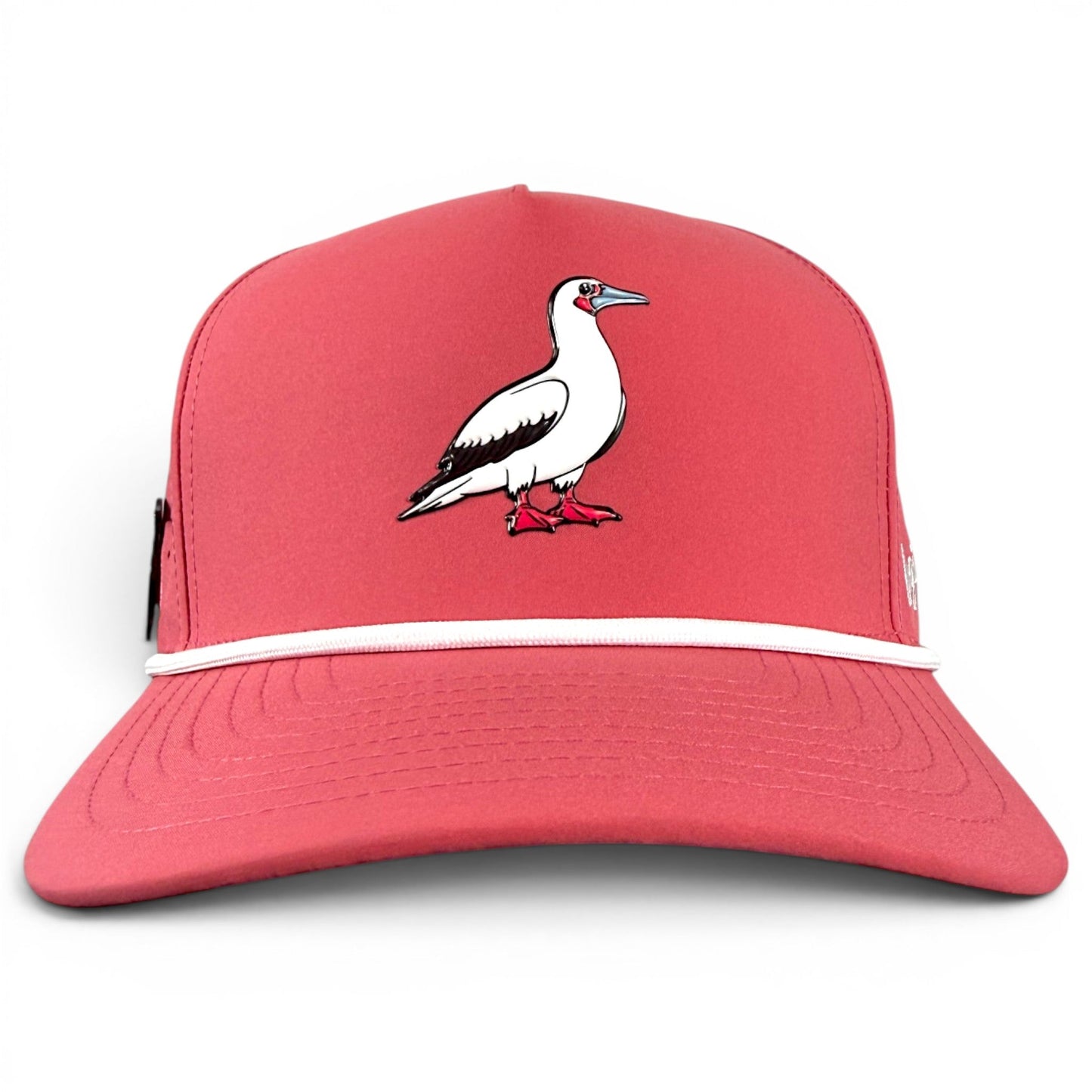 The Logie Joe’s Golf Redfoot Birdie Golf Hat is a red snapback cap featuring a white Red-footed Booby illustration, accented with pink feet and facing right at the center front. This adjustable hat includes a thin white trim above the brim and boasts a built-in magnetic ball marker holder with marker included, offering both style and functional convenience for golfers.