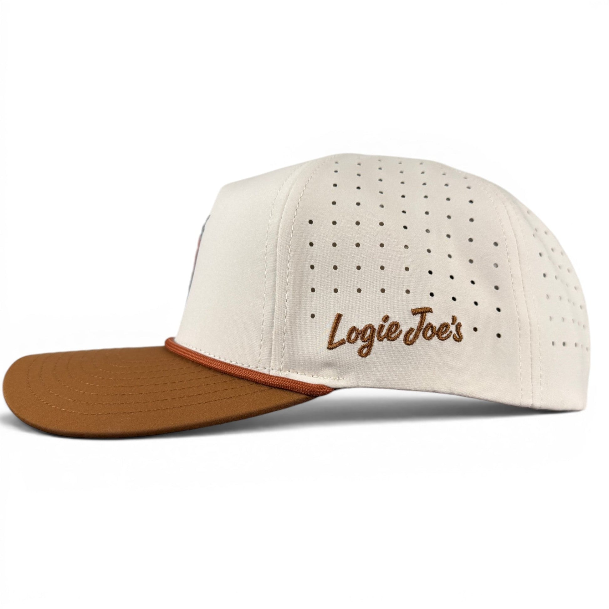 A white Old Fashioned Golf Hat from Logie Joe’s Golf features a brown brim, “Logie Joe’s” embroidered on the side, and small ventilation holes in rows along the sides and back. This adjustable snapback cap also includes a built-in magnetic ball marker holder with marker included, blending classic style with practical functionality.