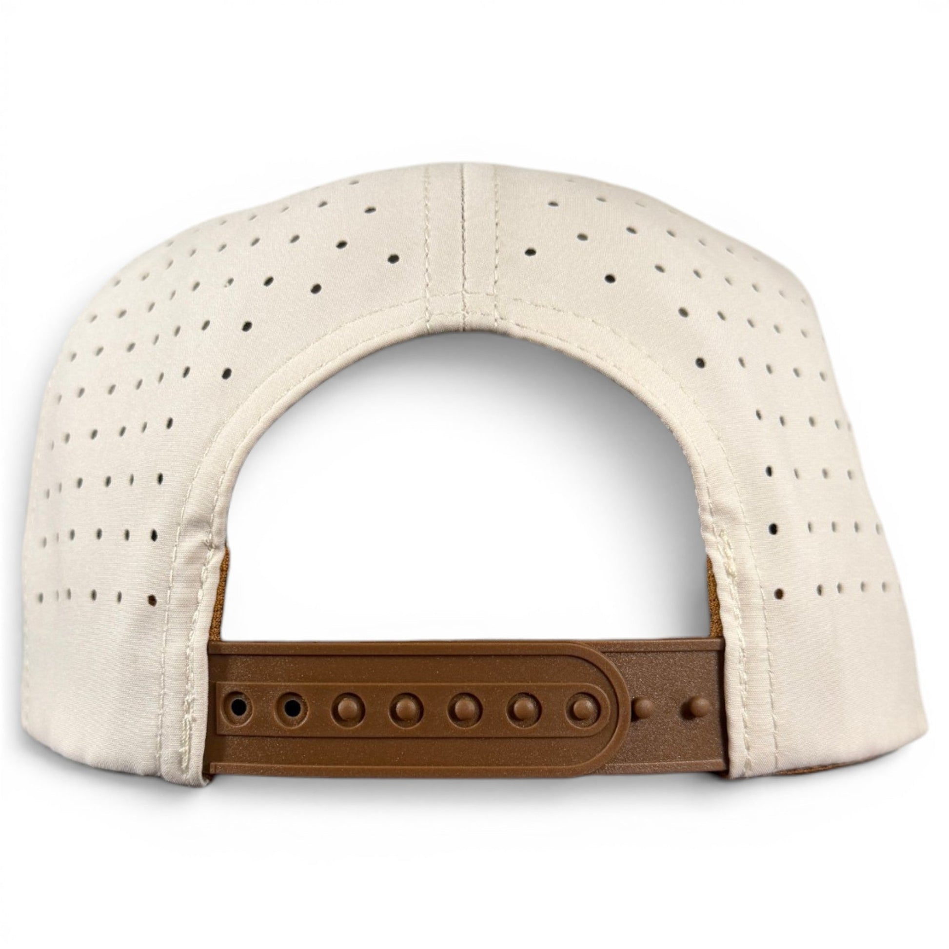 Here’s a revised version using your product data: The Old Fashioned Golf Hat by Logie Joe’s Golf is a beige snapback cap, viewed from the back, with small ventilation holes throughout the fabric and a brown adjustable strap. Reminiscent of vintage golf hats, it features a built-in magnetic ball marker holder with marker included.