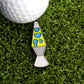 A white golf ball sits on green grass next to the Ballmarkers.com Lava Lamp Ball Marker, featuring bright blue and yellow details—a playful reminder to stay in the flow on the course.