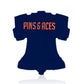 The Liberty Bell - Ball Marker by Pins and Aces is a navy blue, bell-shaped golf accessory featuring "PINS & ACES" in bold orange letters on a white background—perfect for any golf enthusiast.