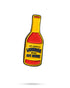 The Louisiana Hot Sauce Ball Marker from Pins and Aces is a pin shaped like a hot sauce bottle, featuring a yellow and red label with "The Original Louisiana Brand Hot Sauce" on a white background.