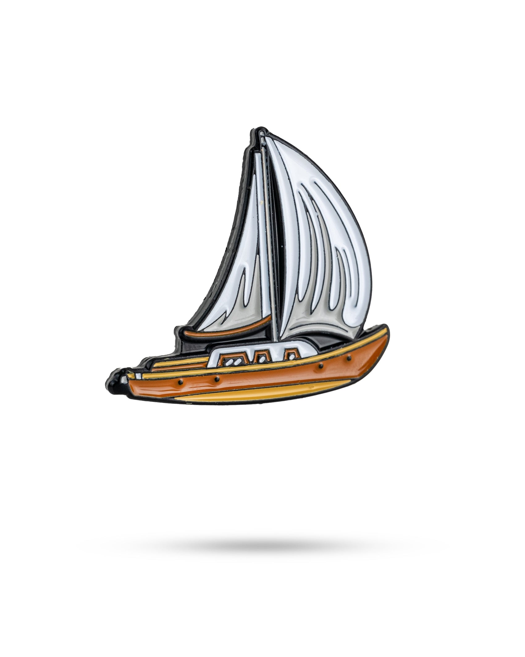 The Margaritaville - Sailboat Ball Marker by Pins and Aces features a small enamel sailboat design with a brown hull and white sails, perfect for marking your golf ball. Shown isolated on a white background with a subtle shadow underneath.