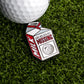 A golf ball on artificial grass sits next to Logie Joe’s Golf Milk Carton "Missing Ball" Ball Marker, a playful novelty pin featuring “Have you seen me? MISSING” and a golf ball image, humorously nodding to the fate of lost balls.