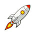 The Pocket Rocket Ball Marker by Ballmarkers.com features a cartoon rocket with a white and gray body, orange nose cone, yellow window, and red-orange flames—ideal for golf fans seeking unique accessories.