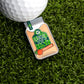 A golf ball sits on artificial grass beside a mason jar-shaped Moonshine Ball Marker by Logie Joe's Golf, labeled "Georgia Peach," featuring a peach illustration and a green lid.