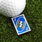 A golf ball sits on artificial grass beside Logie Joe's Golf Mulligan Reverse Card Blue—a fun UNO-style marker with "MULLIGAN" in yellow on blue, ideal for fans of unique golf ball markers and premium accessories.