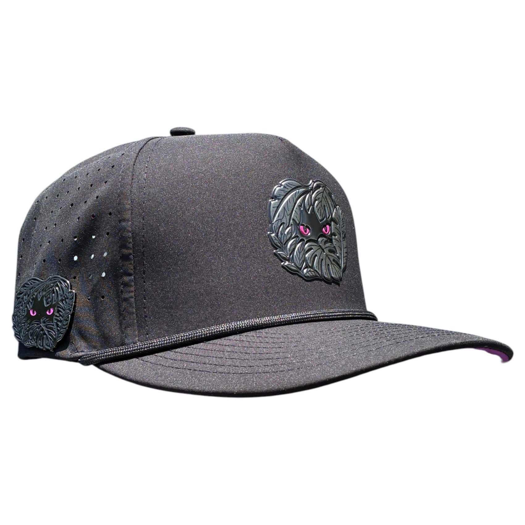 The Logie Joe's Golf Night Stalker Golf Hat is a black snapback cap with an adjustable fit, features animal eyes patches, perforated ventilation holes for comfort, and includes a built-in magnetic ball marker holder with marker.
