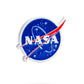 The image features the Pins and Aces NASA "Meatball" Ball Marker, displaying NASA’s blue circular emblem with white letters, a red swoosh, orbital loops, and stars on a white background with a subtle shadow.