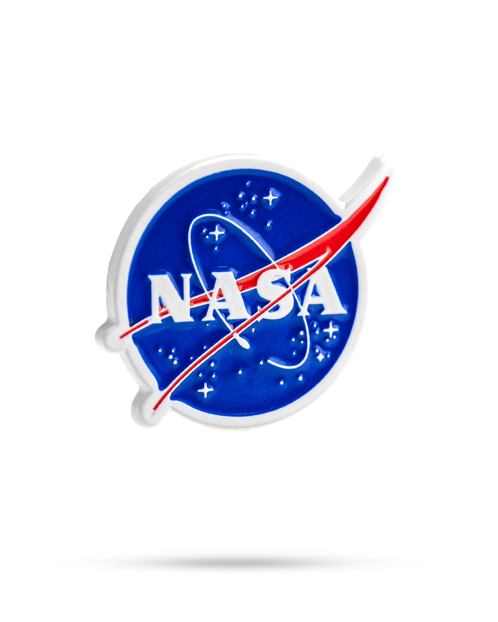 The image features the Pins and Aces NASA "Meatball" Ball Marker, displaying NASA’s blue circular emblem with white letters, a red swoosh, orbital loops, and stars on a white background with a subtle shadow.