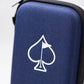 A close-up of the Pins and Aces Glove & Accessory Caddie in navy, featuring a zippered design and a white spade with a small flag. The background is plain and blurred.