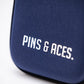Close-up of the Pins and Aces Glove & Accessory Caddie in navy, featuring white "PINS & ACES." text, rounded edges, and a smooth texture.