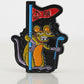 The Pins and Aces Range Rat Ball Marker features a yellow cartoon rat with orange and purple enamel accents, standing on two legs, holding a blue golf club and a red spade-flag with “P&A” text, sporting a mischievous expression.