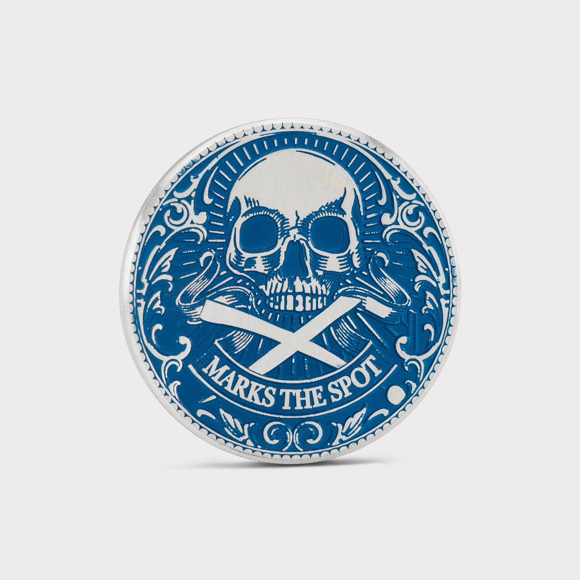 The Silver Omen Antique, Color Edition by Doubloon is a round sterling silver golf ball marker with a blue skull and crossbones, "MARKS THE SPOT" banner, and ornate borders—adding a striking touch to your game.