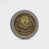 The Doubloon Omen Classic Antique is a round gold and black coin featuring an ornate skull and crossbones with sparkling gemstone eyes and “MARKS THE SPOT” engraved below.
