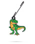 The Pins and Aces T-Rex Ornament is a green and orange cartoon dinosaur keychain, perfect for your golf bag as a fun Christmas accessory, shown hanging from a black hook against a white background.