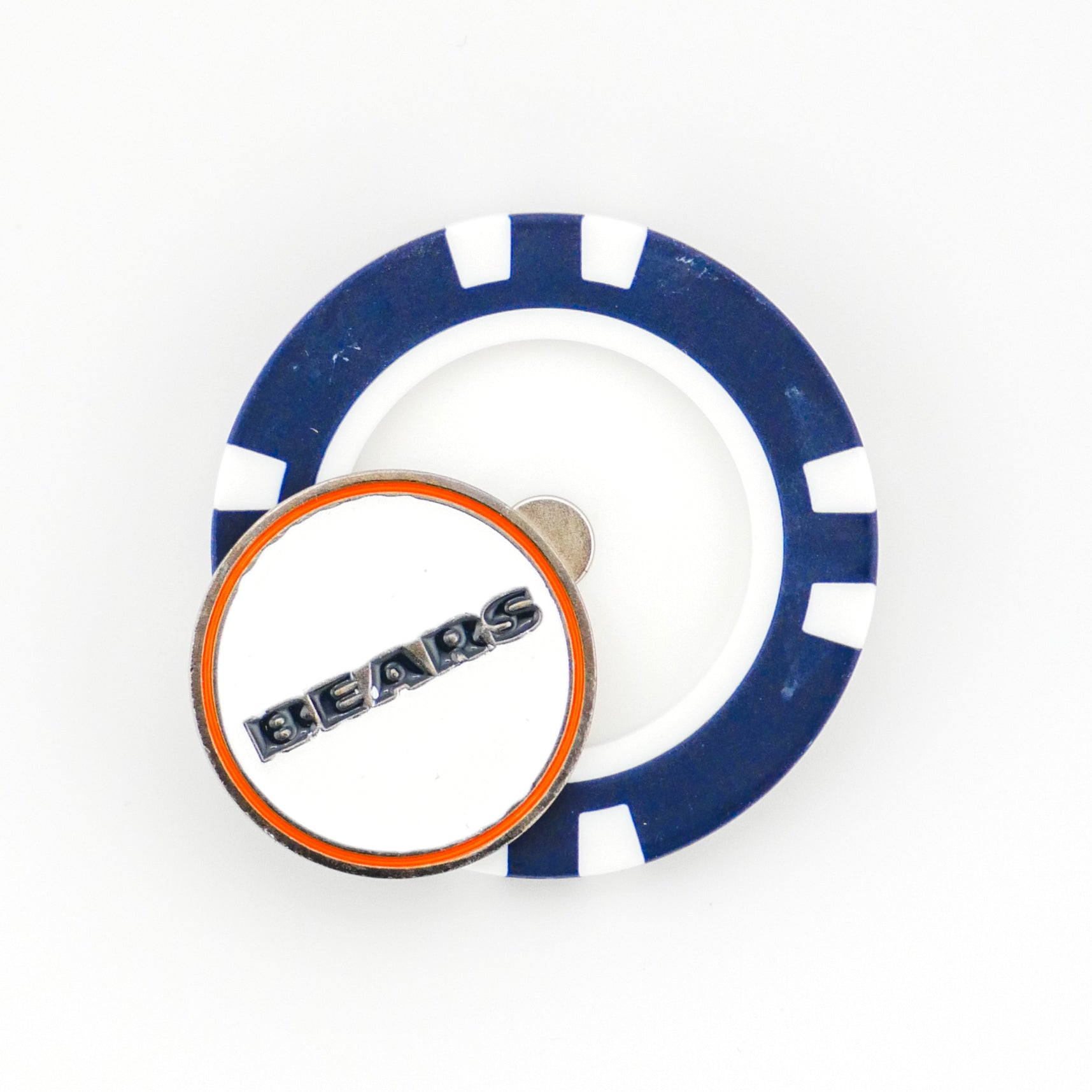 A blue and white poker chip ball marker lies flat with a round, orange-bordered Chicago Bears NFL marker by Ballmarkers.com resting on top.