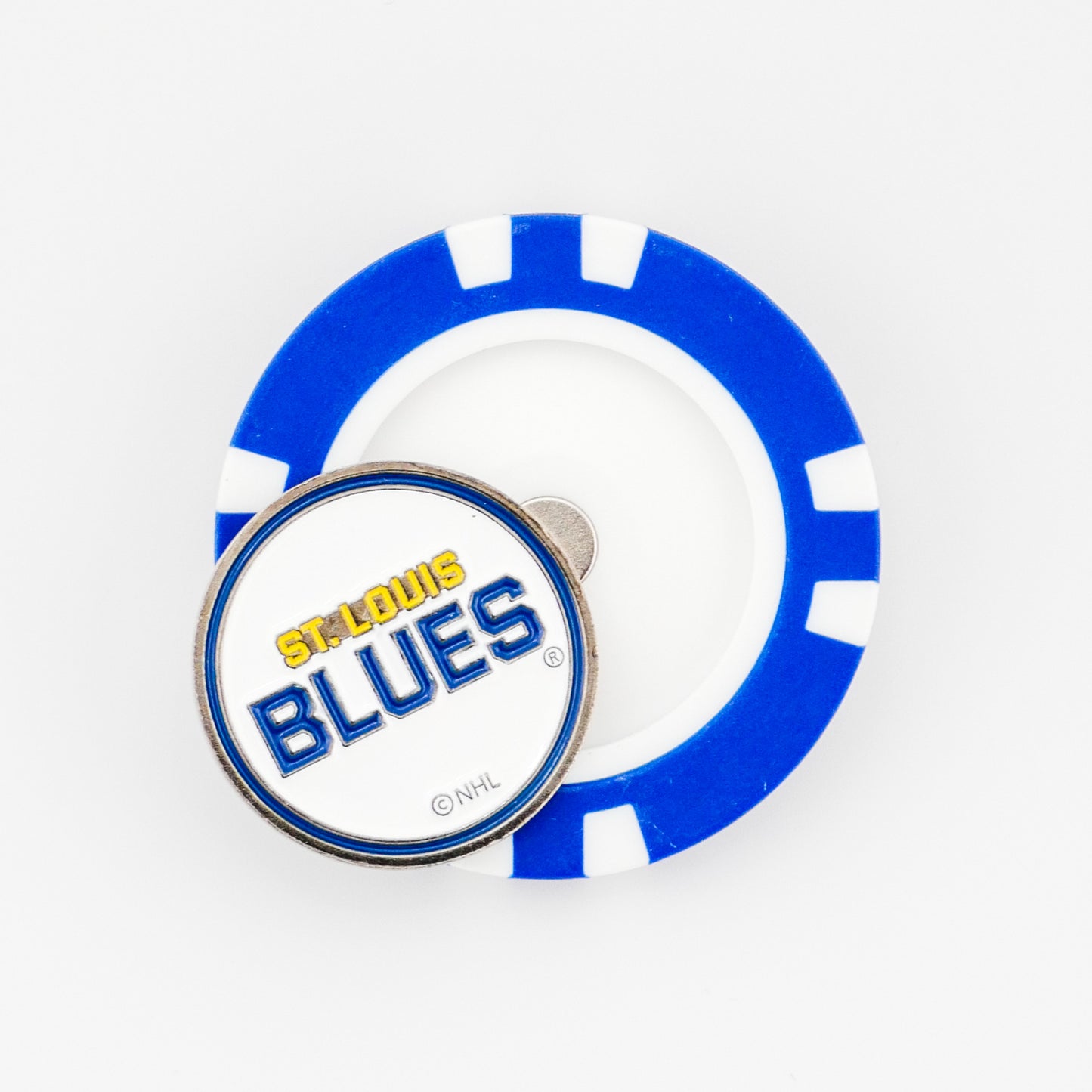 A St. Louis Blues ball marker by Ballmarkers from Logie Joe’s sits atop a blue and white poker chip on a white background, making a unique poker chip-style marker for fans.
