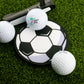A Logie Joe's Golf Soccer Ball Putting Disk, a golf putter, and three white golf balls are set on artificial green grass for focused practice.