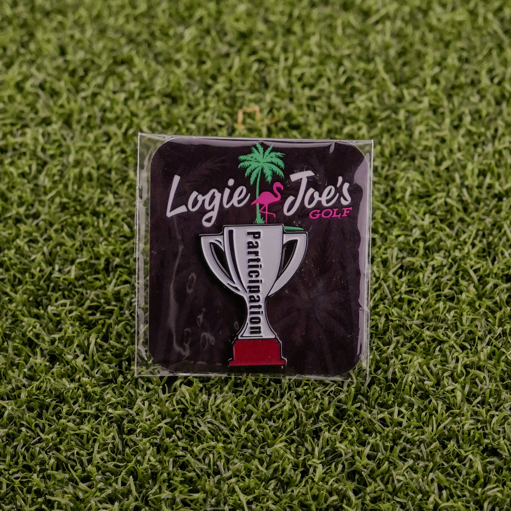 Showcase your enthusiasm with the Participation Trophy square pin by Logie Joe's Golf, featuring a trophy over a black background—perfect for enhancing your premium golf accessories collection.