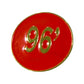 The Grunk Dolfer Tour Champ Ball Marker is a round red marker with gold edges and a gold 96 at the center, ideal as a stylish magnetic hat clip or unique golf gift.