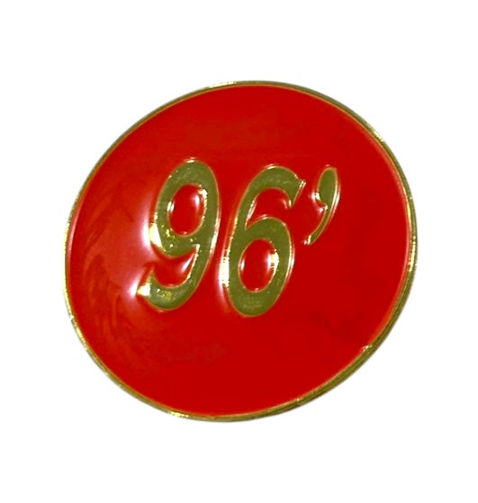 The Grunk Dolfer Tour Champ Ball Marker is a round red marker with gold edges and a gold 96 at the center, ideal as a stylish magnetic hat clip or unique golf gift.