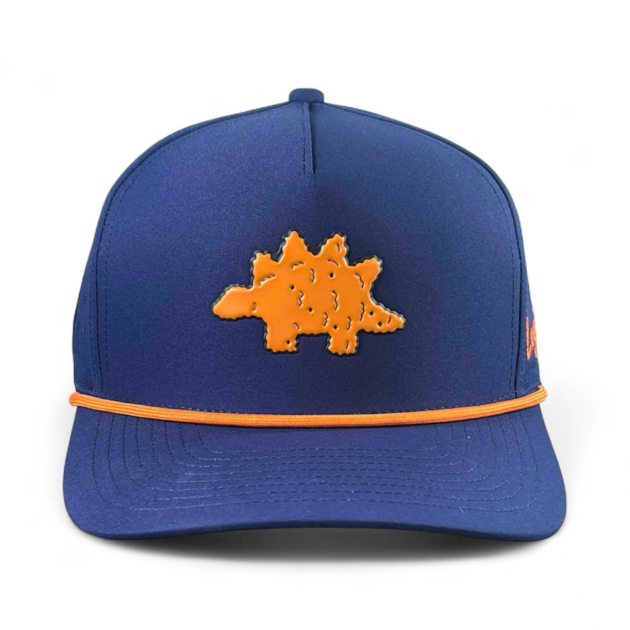 The Logie Joe's Golf Dino Nugget Snapback Hat + Matching Ball Marker is a blue hat with an orange stegosaurus patch on the front and orange trim along the brim.