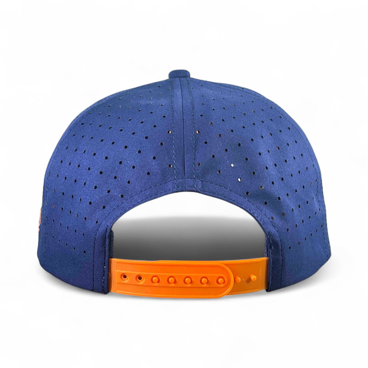 A blue perforated Dino Nugget Snapback Hat by Logie Joe's Golf is shown from the back, displaying an orange adjustable snap closure. This magnetic golf hat comes with a matching ball marker for playful style and convenience.